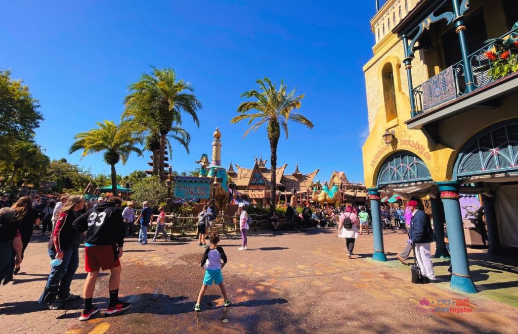 Disney Magic Kingdom Adventureland Wide view with Aladdin Magic Carpet Ride. Keep reading to learn more about Tortuga Tavern in Adventureland Magic Kingdom. 