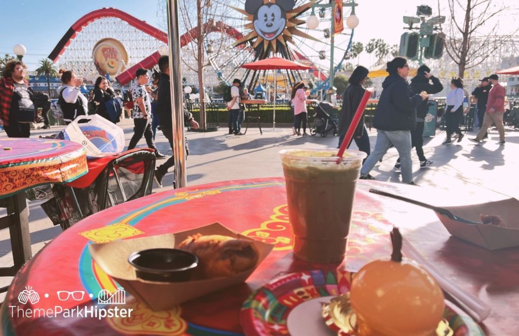 Disneyland Resort Lunar New Year Celebration in Pixar Place at Disney California Adventure Quesabirria Egg Roll, Coconut Lavendar Ice Coffee, Mandarin Mousse Cake. One of the best things to do at Disneyland and Disney California Adventure for Adults.
