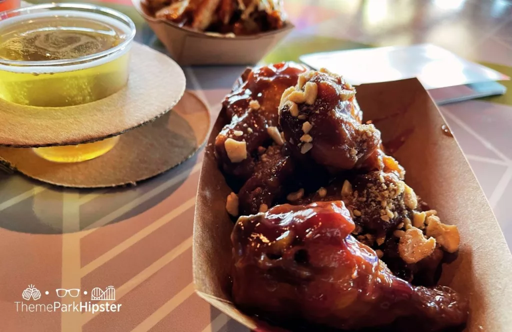 2024 Epcot Food and Wine Festival at Disney Odyssey Cider Flight with Parmesan and Peanut Butter and Jelly Chicken Wings