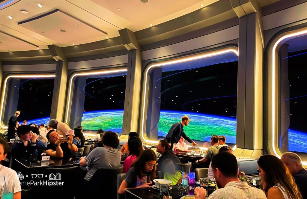 Space 220 Restaurant at Epcot in Walt Disney World dining room. One of the best restaurants at Epcot. Keep reading to find out more about which Orlando theme park is the best.