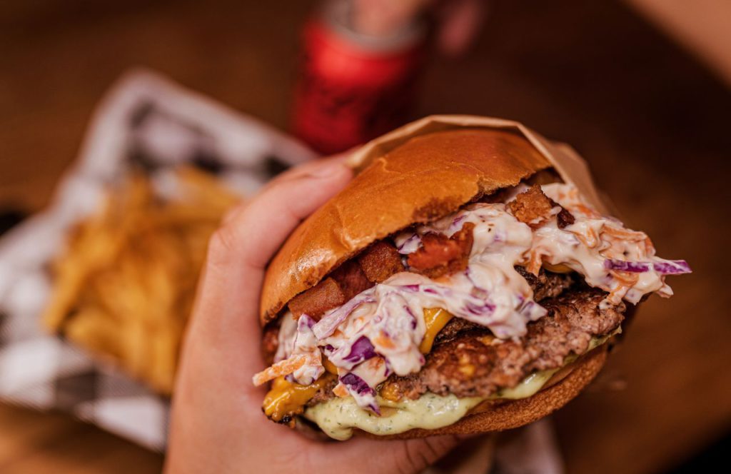 Burger with coleslaw at Blacktap Craft Burgers in Disneyland Resort. One of the best restaurants in Downtown Disney Anaheim