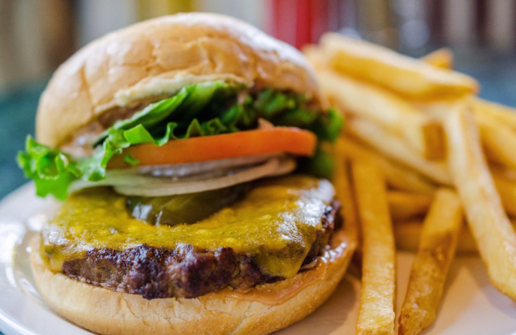 Cheeseburger with lettuce tomatoes and onions 