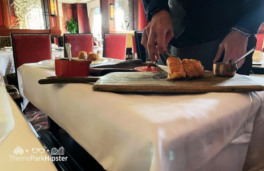 Fried Chicken being prepared tableside Bull and Bear Steakhouse Orlando at Waldorf Astoria Hotel Bonnet Creek Hilton Signia Hotel at Disney World. Keep reading for the full guide to Hilton Signia Hotel at Disney World.